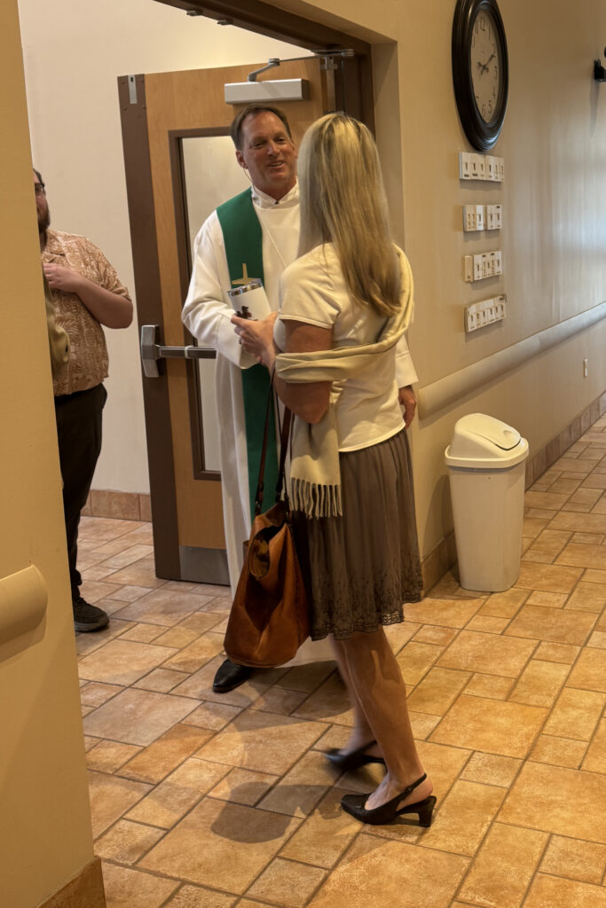 Victory Lutheran Church pastor greeting a parishoner